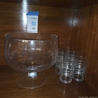 punch bowl on shelf with five glasses visible