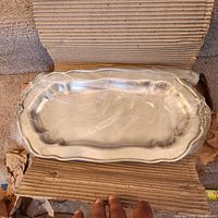 Tray in plastic wrap within original corrugated box