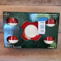 Front of boxed set showing four cups and center saucer opening