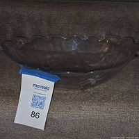 Side view of clear glass bowl showing scalloped rim and etched floral design