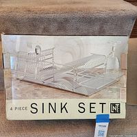 retail box showing Linens n Things 4-piece chromed steel sink set