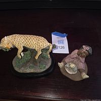Both figurines side by side on surface