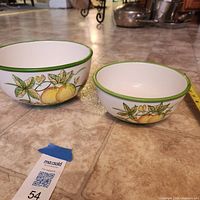 Both bowls nested showing design, tape measure for scale