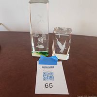 Both crystal paperweights standing side by side