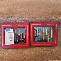 Two identical Perry Ellis Portfolio 6-piece grooming sets in unopened red boxes