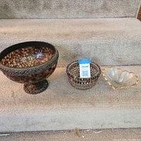 All three bowls lined up on stair: stone mosaic pedestal bowl, beaded wire bowl, glass scalloped dish