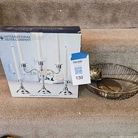 Box labeled International Silver Company beside wire bowl and ladle