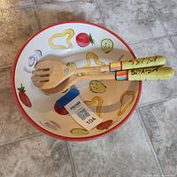 Top view of bowl interior with vegetable design and utensils