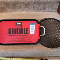 Rectangular griddle with red label alongside round perforated pan