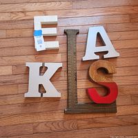 Group shot of all five decorative letters on floor