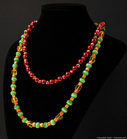 Both necklaces displayed on black bust to show color and hanging length