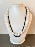 Both necklaces draped on bust form showing lengths and bead styles