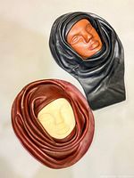 Front view of both leather masks showing colors and design