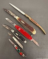 All six folding knives laid out closed and partially opened