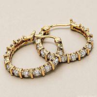 pair of gold plated hoop earrings with clear stones