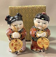 Front view of both porcelain figurines with box
