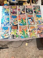 Sixteen Alpha Flight comics laid out in four rows, all in bags