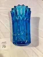 Full view of cobalt blue pressed glass vase standing upright
