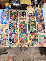 Group shot of 16 bagged Legion-related comic books laid out on table