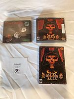 Overview showing all three game packages: Diablo II big box, Diablo II jewel case, Westwood jewel case