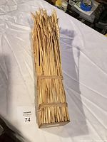 Front view of entire dried wheat bundle with twine binding