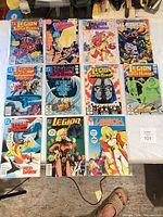 Group shot of all twelve bagged Legion of Super-Heroes comic books laid out in three rows of four.