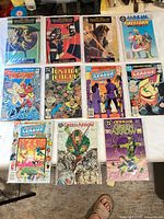 All ten bagged and boarded comic books laid out on table