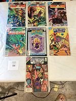 Group shot of all seven bagged comics laid out in rows