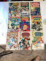 Nine bagged Power Pack comics laid out 3×3 showing all covers
