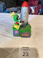 Front view showing Marvin figure, rocket, front panel text