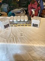 Group of glass spice jars, boxed stoneware jars visible