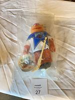 Full view of sealed plush in bag with accessories and tag visible