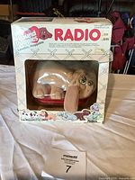 Front view of Pound Puppies radio plush toy in window box