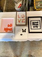 Overview of all four framed prints on table
