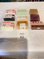 Nine wrapped glycerin soap bars laid out on table with lot number