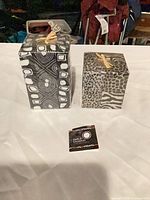 Both patterned black & white pillar candles with branded tag