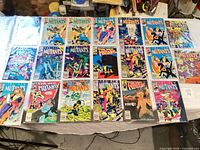 Overhead view showing all comic book covers laid out, confirming count exceeding twenty and range of issues