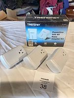 Front of TRENDnet Powerline kit box with three Smartenit smart plugs