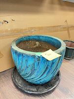 Full view of blue ceramic pot on black base