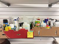 Overview of two trays filled with cleaning products