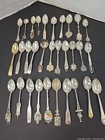 All 29 spoons laid out in rows showing full lot