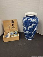 Full view of porcelain crane vase and boxed sake set