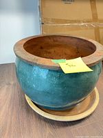Overall view of glazed ceramic planter on saucer