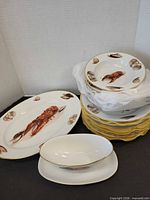 Stacked plates and bowls with platter showing lobster motif