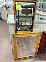 Front view of both mirrors leaning against cabinet