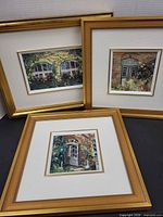 All three framed paintings grouped together
