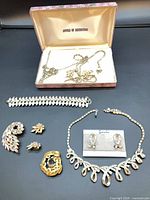 Overview of all jewellery pieces laid out including Jewels of Distinction box and Starlite earrings