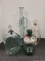 Group shot of all four bottles showing size, shapes and colours