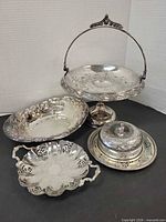 Group shot showing all four silver-plated serving pieces