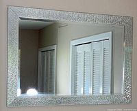 Front view of rectangular mirror showing full mosaic frame